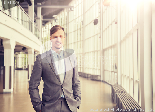 Image of young businessman in suit at office building hall