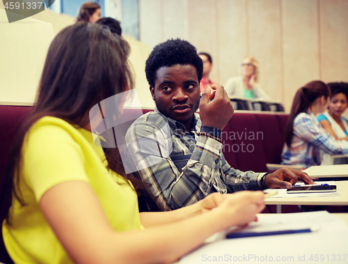 Image of group of students with notebooks at lecture hall