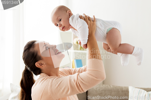 Image of happy mother playing with little baby boy at home
