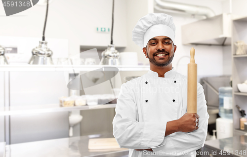 Image of indian chef or baker with rolling-pin at kitchen