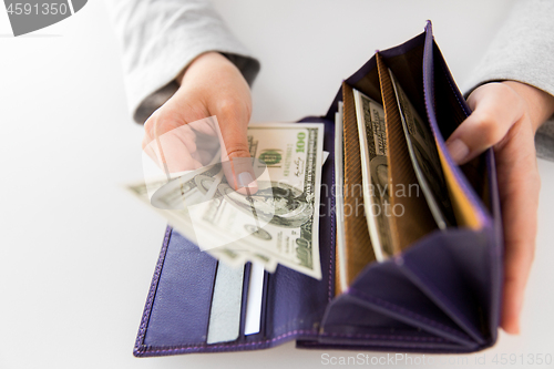 Image of close up of woman hands with wallet and us money