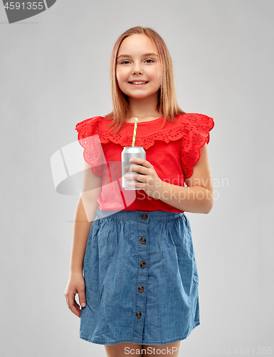 Image of smiling preteen girl drinking soda from can