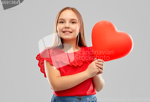 Image of smiling girl with red heart shaped balloon