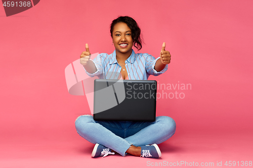 Image of happy african american woman with laptop computer