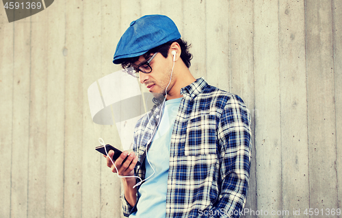 Image of man with earphones and smartphone listening music