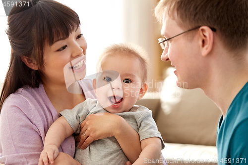 Image of happy mixed-race family with baby son at home