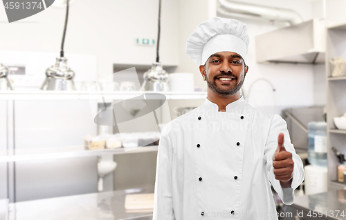 Image of indian chef showing thumbs up at kitchen