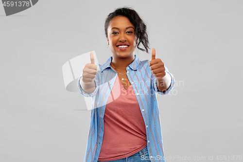 Image of happy african american woman showing thumbs up