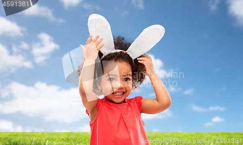 Image of happy little girl wearing easter bunny ears
