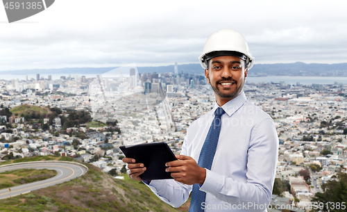 Image of architect or businessman in helmet with tablet pc