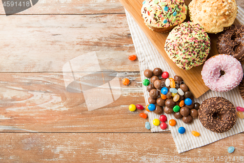 Image of close up of glazed donuts, candies and cupcakes