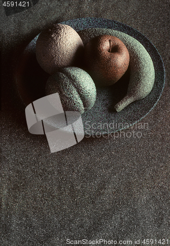 Image of Granite-like sculpture of fruit on a plate