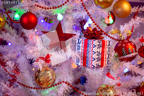 Image of Christmas decorations on artificial white spruce