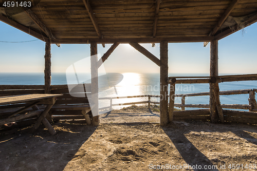 Image of A conversation of wooden beam, on the beach, sunset