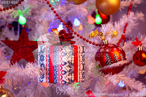 Image of Beautiful small gift on the Christmas tree branch