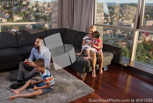 Image of Happy family playing a video game