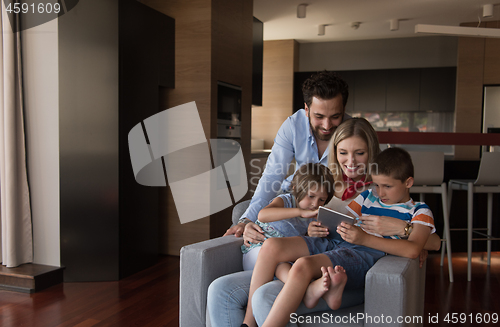 Image of happy young couple spending time with kids