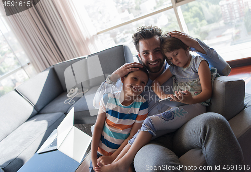 Image of happy young father spending time with kids