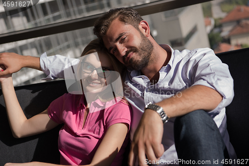 Image of Young couple watching television