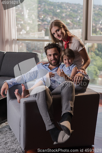 Image of happy young couple spending time with kids