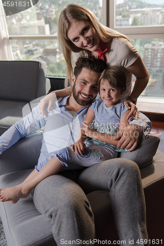 Image of happy young couple spending time with kids