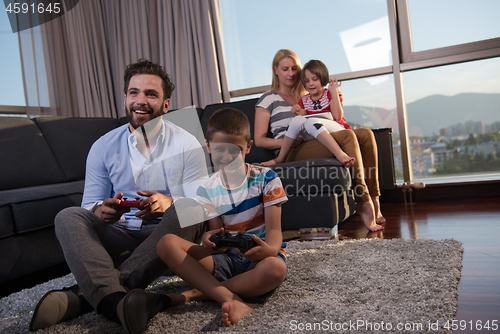 Image of Happy family playing a video game