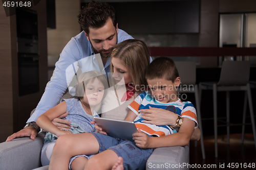 Image of happy young couple spending time with kids