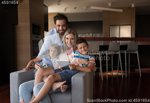 Image of happy young couple spending time with kids