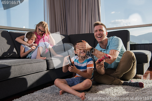 Image of Happy family playing a video game