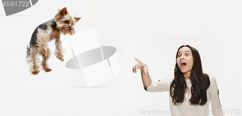 Image of Woman with her dog on leash over white background