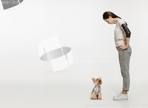 Image of Woman with her dog on leash over white background