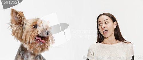 Image of Woman with her dog over white background