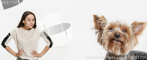 Image of Woman with her dog on leash over white background