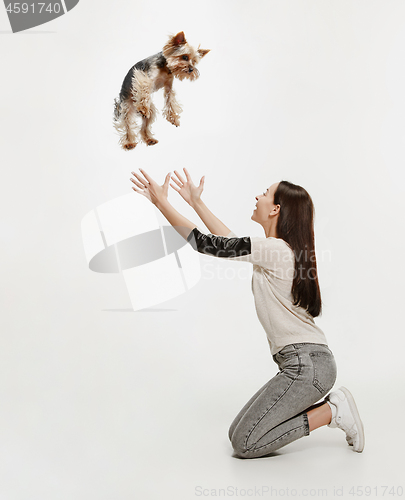 Image of Woman with her dog on leash over white background