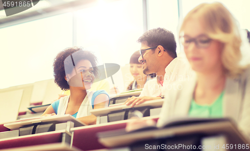 Image of international students talking in lecture hall