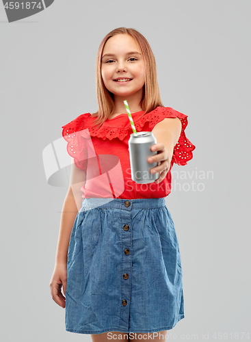 Image of smiling preteen girl drinking soda from can