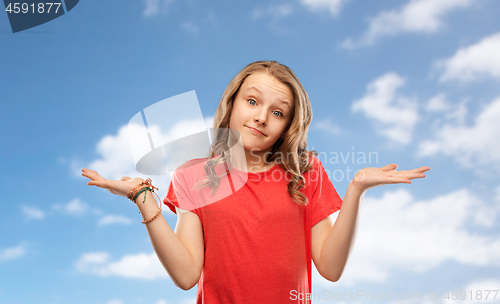 Image of wondering teenage girl in red t-shirt shrugging