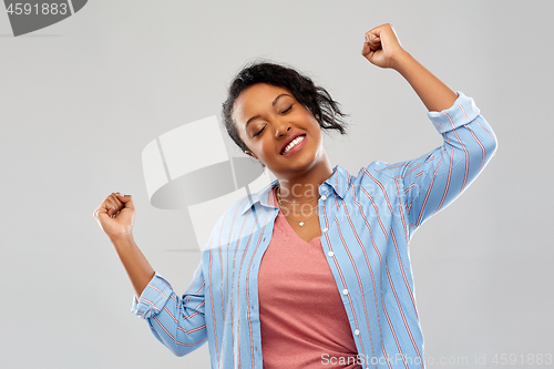 Image of happy african american woman celebrating success