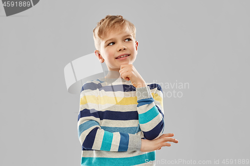 Image of portrait of thinking boy in striped pullover