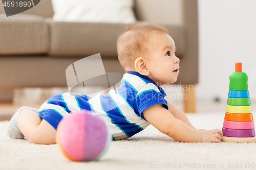 Image of sweet little asian baby boy playing with toy ball