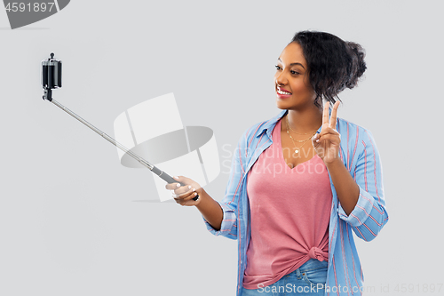 Image of african american woman taking selfie by smartphone