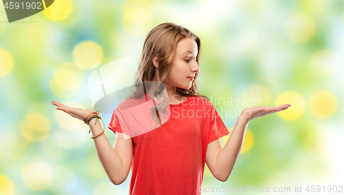 Image of smiling teenage girl holding empty hand