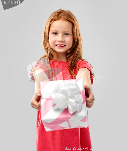 Image of lovely red haired girl with birthday gift