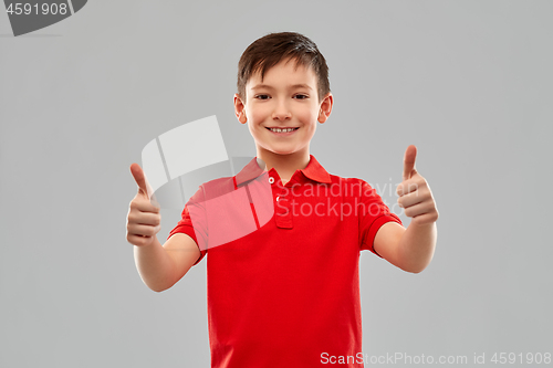 Image of smiling boy in red t-shirt showing thumbs up