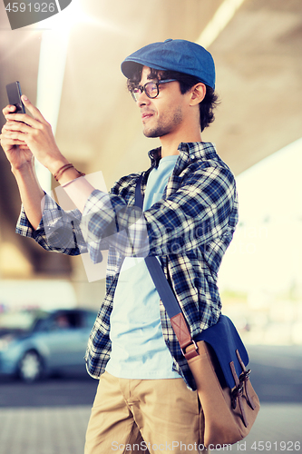 Image of hipster man taking selfie on smartphone