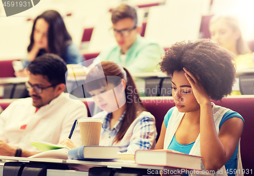 Image of group of students with coffee writing on lecture