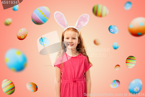 Image of happy red haired girl wearing easter bunny ears