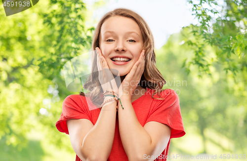 Image of smiling teenage girl over natural background