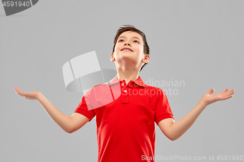 Image of happy grateful boy in red t-shirt looking up