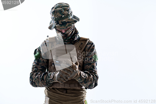 Image of closeup of soldier hands putting protective battle gloves